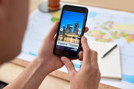 holiday deals vacation packages offered on mobile cellphone smartphone app application, information technologyの写真素材