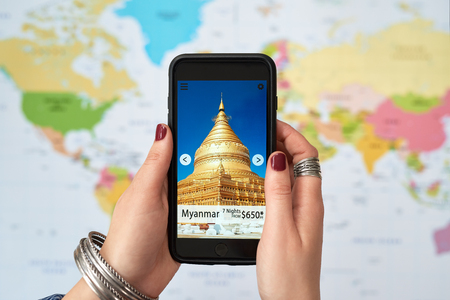 young woman wanderlust vacation holiday inspiration adventure looking at smartphone travel app applicationの写真素材