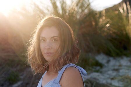 Portrait of beautiful woman at the beach sunlight in her hairの写真素材