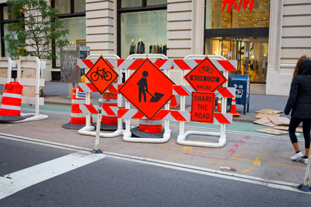 New York, NY, USA - Jan 7, 2021: Traffic warning signs regarding road work waiting to be moved as needed onto Fifth Avenueのeditorial素材