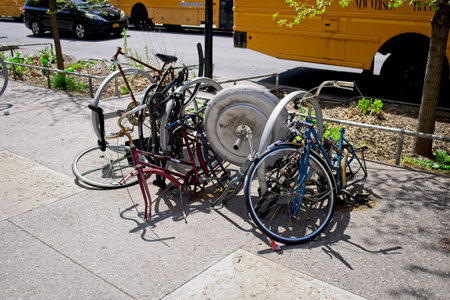 New York, NY, USA - Apr 28, 2021: Bicycles that have been torn apart fastened to a bike rack near...
