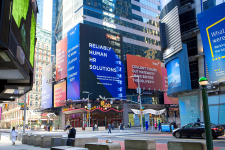 New York, NY, USA - May 5, 2021: Times Square showing large billboards above subway entrance at 7th...