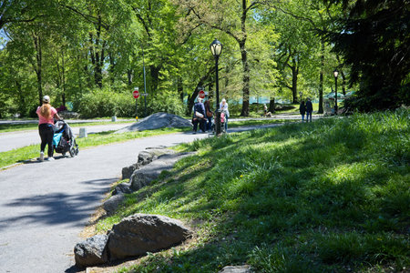 New York, NY, USA - May 9, 2021: People walking through Central Park on a bright sunny dayのeditorial素材