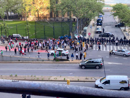 New York, NY, USA - May 20, 2021: Pro-Palestinian demonstrators marching up First Avenue alongside police barricade.のeditorial素材