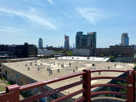 Brooklyn, NY, USA - July 15, 2021: Exhaust fans on factory roof in Greenpoint as seen from the Pulaski Bridge pedestrian pathのeditorial素材