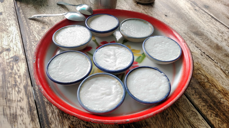 coconut milk custard in small porcelain cup on the retro zinc plateの写真素材