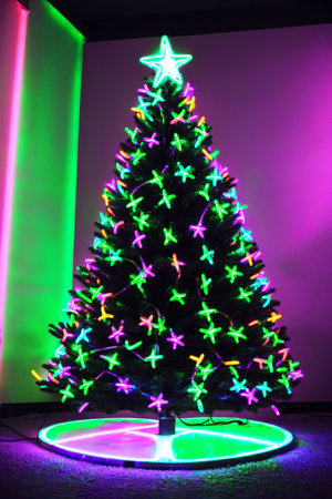 Dark christmas tree illuminated with neon lights on dark background, wallpaper christmas banner Ai Generatedの素材