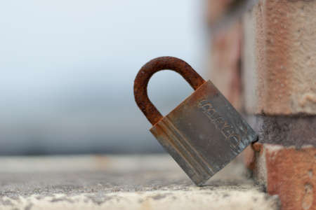 there is a locked door in an ald house in our street. there is rust.の写真素材