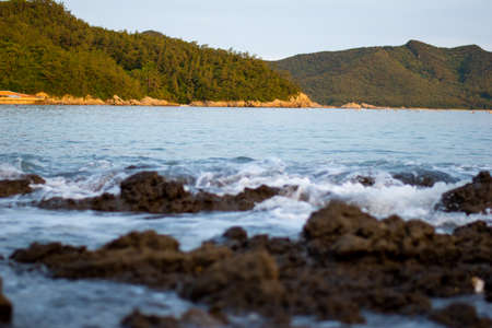 the waves come in with the big jungle looking. rocks in the middle of the seaの写真素材