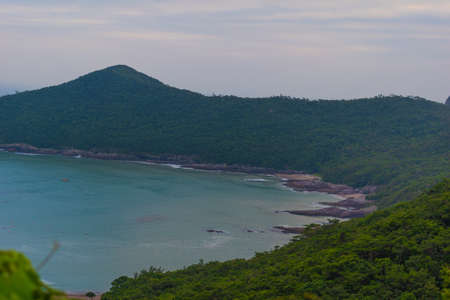 background image. the view of the beach from the top of the hill with the jungleの写真素材