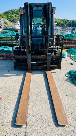 Forklift loading fishing nets into the port. Fishing industry.