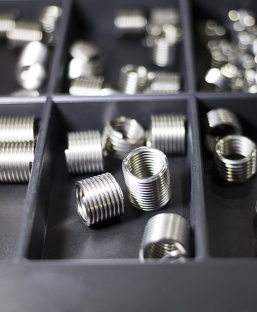 Small spring parts keep in black partition box: Selective Focusの写真素材