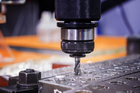 Tapping tool in spindle tapping into a hole in steel plate;Tapping machine;selective focusの写真素材