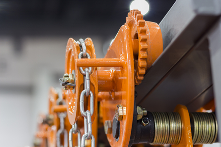Industrial Steel Chains in orange hoists ; Selective focusの写真素材
