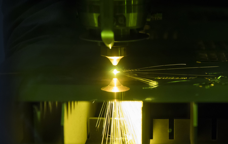 laser cutting metal plate ; sparks light