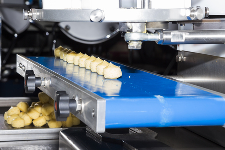 food in conveyor of machine ; selective focusの写真素材