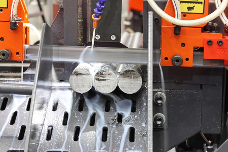 Steel bar cutting by band saw machine with coolant