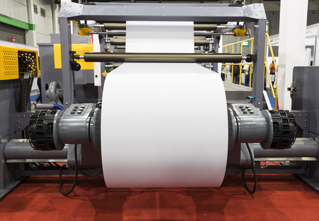 roll of white paper in modern paper cutting machineの写真素材