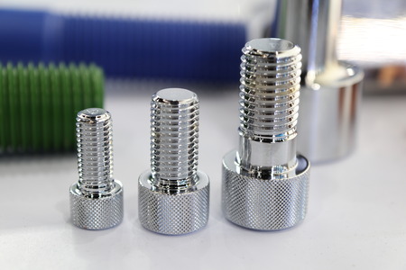 the small bolts and nuts for industrial machine ; selective focus