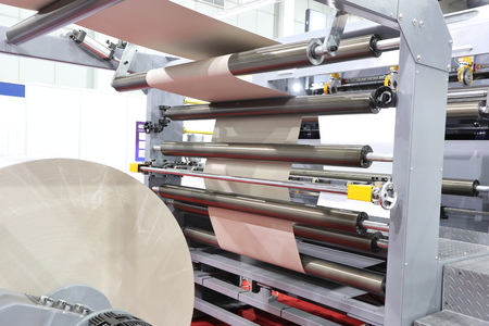 roll of white paper in modern paper cutting machine
