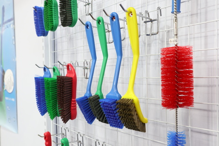 plastic cleaning brushes in supermarket hanger ; close upの写真素材