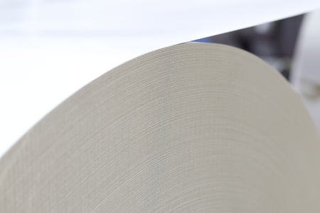 roll of white paper in modern paper cutting machine