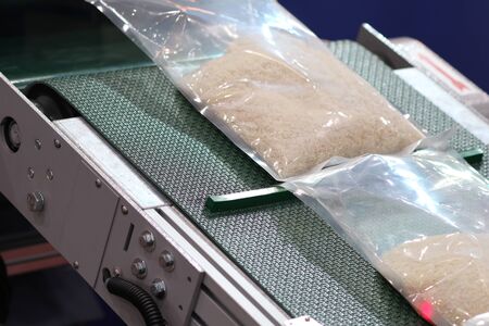 rice packing in plastic bag on conveyor line ; close upの写真素材