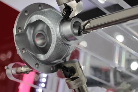 iron casting demonstrate to be machined by cutting tool of cnc machining process ; industrial...