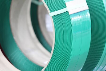 Green PP band for packaging and fastening of carton box ; Business industrial background 