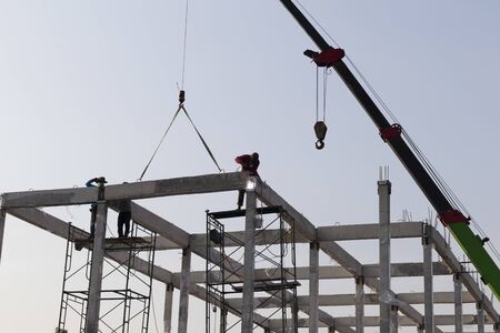 precast concrete beam installed at construction site by mobile crane  ; welding bar rod ; civil...
