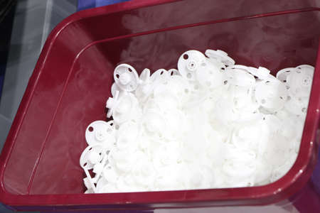 white plastic gear made by injection process in plastic boxの写真素材