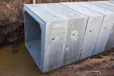 Large size square concrete manholes are  installed at construction site ; for draining storm water of main road ; civil constrution backgroundの写真素材