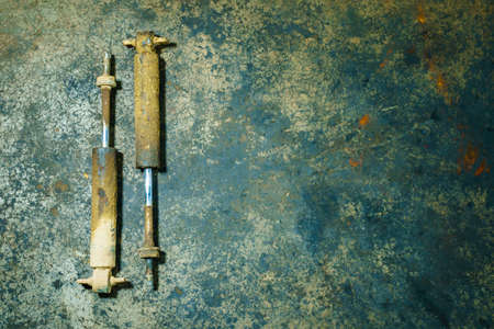 old shock absorber expire on dirty ground. suspension system truckの写真素材