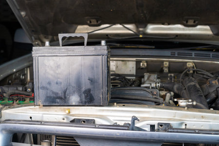Closeup of a car engine with a battery on the hood carの写真素材