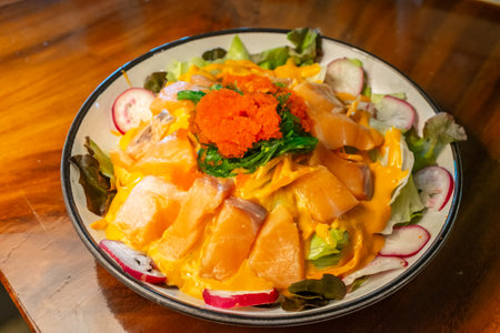 Fresh salmon salad with sauce with shrimp eggs, green seaweed and fresh vegetables.Healthy food with vegetables is beneficial.の写真素材