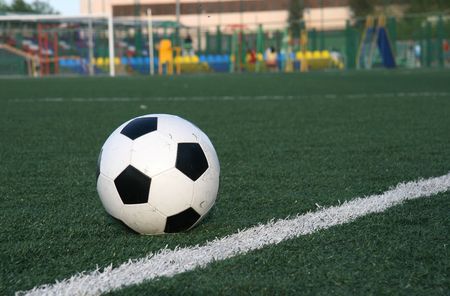 Football in stadium with an artificial covering before the beginning of game. の写真素材