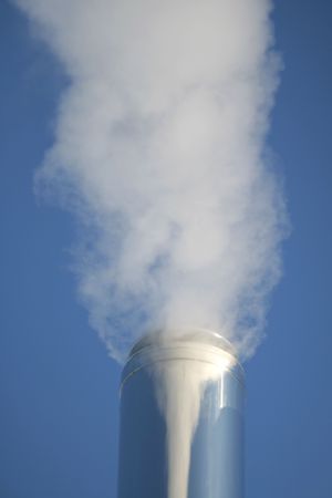 Chimney on a background of a blue smoke