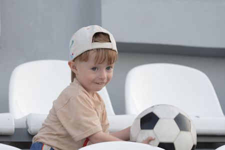 The boy with a toy on empty tribunes of stadiumの写真素材