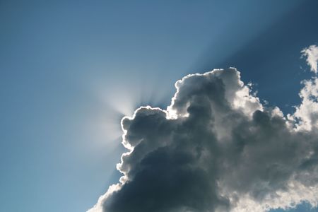 Sunlight because of a cloud on a background of the blue skyの写真素材