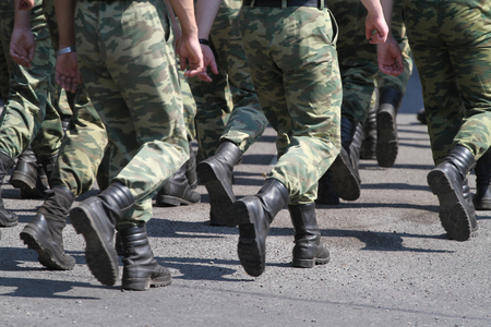 The division of soldiers carries out transition on city streetの写真素材