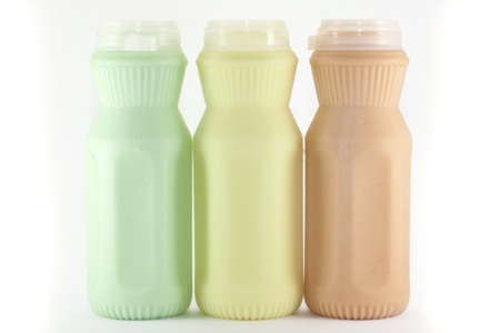 milk (melon,corn,tea and coffee taste) in a plastic bottle on a white backgroundの写真素材