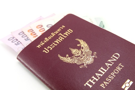 Thailand passport and Thai money on white backgroundの写真素材
