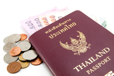 Thailand passport and Thai money on white backgroundの写真素材