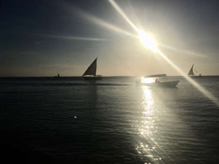 Silhouette of a ship in backlight on Zanzibarの写真素材