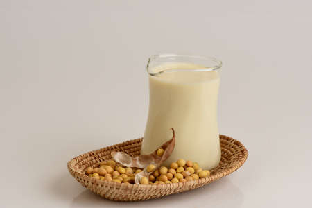 Soy milk and soy bean, made from soy bean have medicinal properties and on a white background.の写真素材
