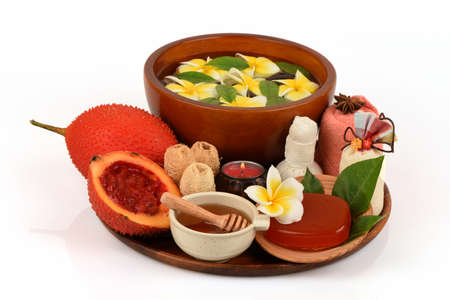Face mask and soap with gac fruit extract and honey, spa treatment concept, medicinal properties on a white background.の写真素材