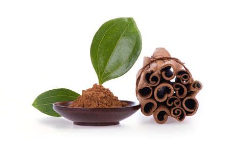 Cinnamon dried peel and powder isolated on a white background.の写真素材