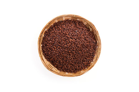 Dried garden cress seeds in a bamboo basket isolated on whiteの写真素材