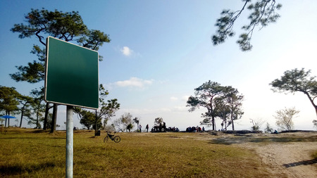 Blank green sign on mountain background