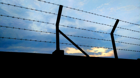 Barbed wire fence with Twilight skyの写真素材